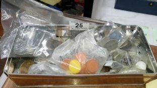 A tin of mixed tokens,