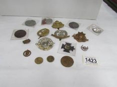 A small collection of cap badges,