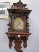 An oak brass faced wall clock