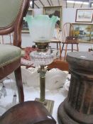 A brass Corinthian column oil lamp with glass font and later etched shade