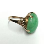 A Chinese grade A apple green jadeite jade stone mounted in a ring, cabouchon cut, 17.8 grams, 19.
