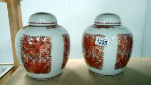 A pair of oriental lidded jars