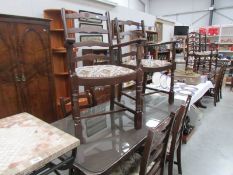 An oak refectory table with protective glass top and a set of 6 chairs