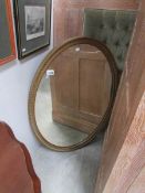 An oval bevel edged mirror