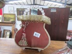 A vintage table lamp in the shape of a hand bag