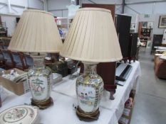 A pair of oriental style table lamps with shades