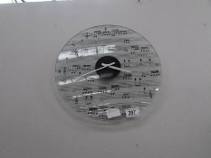 A glass music themed wall clock