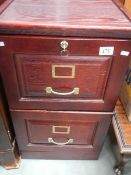 A wooden 2 drawer filing cabinet