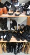 3 shelves of mainly new boots and shoes