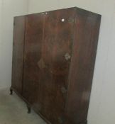 A walnut 3 door wardrobe with ornate brass fittings