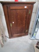 An oak corner cupboard