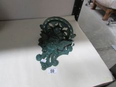 A cast metal green man wall bracket