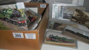 A box of assorted old postcards including railway,