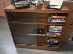 A 1950's oak bookcase with sliding glass doors
