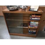 A 1950's oak bookcase with sliding glass doors