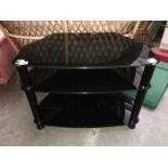 A 3 tier black glass effect TV stand