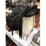 A Teqnic horse saddle with stirrups, girdle, girth, bridle,