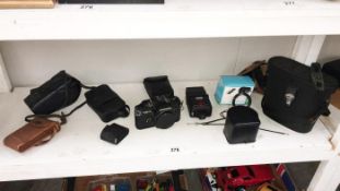 A quantity of cameras & binoculars