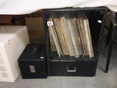 A cabinet with a quantity of LP records and a case of 45rpm records