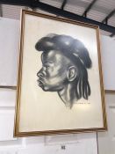 A framed and glazed charcoal drawing of an African woman signed Scabbia 58