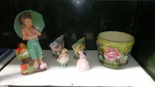 A collection of figurines including Victorian & a jardinier