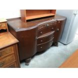 A serpentine front hall sideboard