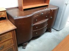 A serpentine front hall sideboard