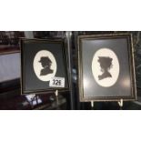 A pair of framed silhouettes