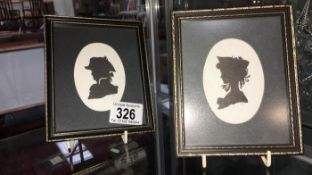 A pair of framed silhouettes