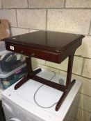 A table with a pull out drawer