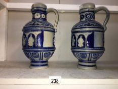 A pair of Grecian style ewers