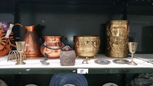 A shelf of copper & brassware