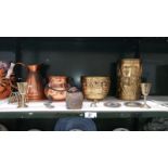 A shelf of copper & brassware