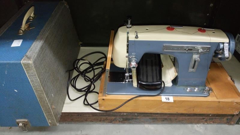 A vintage cased Zig Zag sewing machine