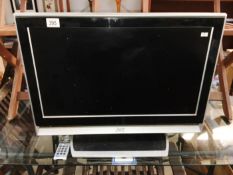 A JVC flat screen TV with remote control