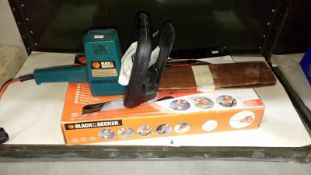 A Black & Decker powered hand saw & Black & Decker hedge trimmer