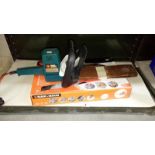 A Black & Decker powered hand saw & Black & Decker hedge trimmer