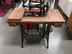 A treadle sewing machine with cast company name 'Indian'