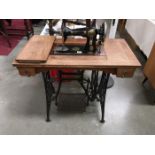 A treadle sewing machine with cast company name 'Indian'