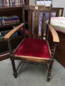 An oak framed arm chair with barley twist legs