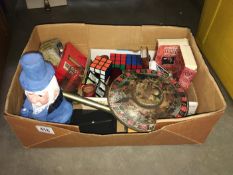 A box of old games including cards, spinning tops, rubiks cubes etc.