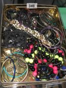 A tin of costume jewellery bangles & bracelets