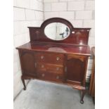 A mahogany sideboard with mirror