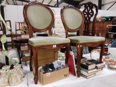 A pair of hall chairs with green upholstered seats and backs