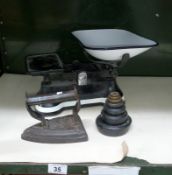 A set of scales with weights & an old iron