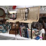 A pair of metal frame chairs with wicker seats