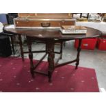 A drop leaf oval table