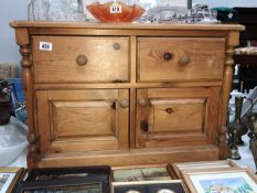 A solid pine 2 drawer cupboard
