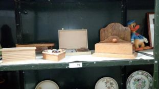 A shelf of wooden items including camel solitaire board