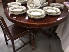 A circular extending inlaid dining table